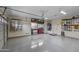 View of a clean and well-organized garage with epoxy floors and ample storage space at 2903 E Quenton St, Mesa, AZ 85213