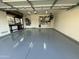 Well-maintained garage showing epoxy flooring, tool bench, and ample space for vehicles and storage at 2903 E Quenton St, Mesa, AZ 85213