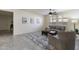 Open living area with plush rug, ceiling fan, and natural light from shuttered windows at 2903 E Quenton St, Mesa, AZ 85213