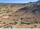 Scenic aerial shot highlighting the rugged desert terrain meeting the residential area, set against a mountainous skyline at 3388 N Highlands Dr # 38, Buckeye, AZ 85396