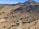 Breathtaking aerial perspective showcasing the natural desert environment adjacent to the community, framed by distant mountains at 3388 N Highlands Dr # 38, Buckeye, AZ 85396
