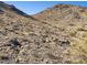 Natural desert terrain with rocky slopes and native vegetation, showing a rugged and untouched environment at 3388 N Highlands Dr # 38, Buckeye, AZ 85396