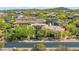 Custom home with unique architectural details is surrounded by desert landscaping in this beautiful aerial view at 37334 N Winding Wash Trl, Carefree, AZ 85377