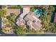Stunning aerial view of the desert home, the perfectly manicured lawn, pool, driveway, and surrounding landscape at 37334 N Winding Wash Trl, Carefree, AZ 85377
