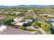 Custom home featuring lush landscaping is surrounded by desert vegetation in this amazing neighborhood aerial view at 37334 N Winding Wash Trl, Carefree, AZ 85377