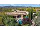 Backyard has a relaxing pool and spa, covered patio space, and lush mature desert landscaping at 37334 N Winding Wash Trl, Carefree, AZ 85377