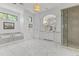 Luxurious bathroom showcasing a soaking tub, marble flooring, and a glass-enclosed shower at 37334 N Winding Wash Trl, Carefree, AZ 85377