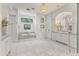 Elegant bathroom featuring a marble-clad tub, and a vanity with ample storage at 37334 N Winding Wash Trl, Carefree, AZ 85377