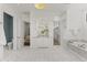 Spacious primary bathroom featuring marble floors, dual vanities, soaking tub, and separate toilet room at 37334 N Winding Wash Trl, Carefree, AZ 85377