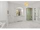 Luxurious bathroom with marble floors, custom vanities, and a glass shower enclosure at 37334 N Winding Wash Trl, Carefree, AZ 85377