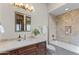 Bathroom with vanity, bath, and shower combination with natural tile surround at 37334 N Winding Wash Trl, Carefree, AZ 85377