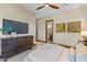 Bedroom with TV and dresser includes access to the en suite bathroom at 37334 N Winding Wash Trl, Carefree, AZ 85377
