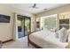 Bedroom featuring a ceiling fan, outdoor access, and a cozy window seat at 37334 N Winding Wash Trl, Carefree, AZ 85377
