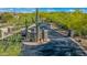Gated driveway lined with desert landscaping and mature cacti leads to a beautiful custom home at 37334 N Winding Wash Trl, Carefree, AZ 85377