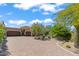 Well-maintained home with a circular driveway, desert landscaping, mature trees, and an attached three car garage at 37334 N Winding Wash Trl, Carefree, AZ 85377