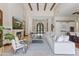 Spacious living room with a cozy fireplace, elegant furnishings, and abundant natural light at 37334 N Winding Wash Trl, Carefree, AZ 85377