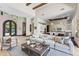 Bright, open living room features high ceilings, wooden beams, and a seamless flow to the gourmet kitchen at 37334 N Winding Wash Trl, Carefree, AZ 85377