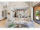 Inviting open-concept living room with a comfortable sofa and seamless access to a modern, stylish kitchen at 37334 N Winding Wash Trl, Carefree, AZ 85377