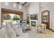 Bright living room with an open sliding door and access to outdoor living spaces by the pool at 37334 N Winding Wash Trl, Carefree, AZ 85377