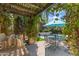 Outdoor patio featuring a built in grill, a dining table, a pool and well manicured plants at 37334 N Winding Wash Trl, Carefree, AZ 85377