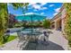 Relaxing pool area with a dining table, green plants and a nice patio at 37334 N Winding Wash Trl, Carefree, AZ 85377