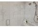 Luxurious marble tiled shower with dual showerheads and built-in bench at 37334 N Winding Wash Trl, Carefree, AZ 85377