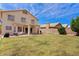 A spacious backyard featuring a covered patio and a lush green lawn, perfect for outdoor entertaining and relaxation at 4422 E Dry Creek Rd, Phoenix, AZ 85044