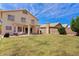 Large, grassy backyard featuring a covered patio area, barbecue and block fencing at 4422 E Dry Creek Rd, Phoenix, AZ 85044