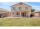 Well-maintained backyard with lush green grass, covered patio, and block fence for privacy at 4422 E Dry Creek Rd, Phoenix, AZ 85044