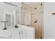 Tiled shower in a bathroom with a large mirror and double sinks at 4422 E Dry Creek Rd, Phoenix, AZ 85044