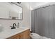 Bathroom with a new vanity, updated hardware, shower with grey curtain, and modern sink at 4422 E Dry Creek Rd, Phoenix, AZ 85044