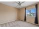 Bedroom with new carpet, ceiling fan, window with a tree view and standard wall electric outlets at 4422 E Dry Creek Rd, Phoenix, AZ 85044