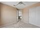 Neutral bedroom with carpet, a ceiling fan, closet and an open doorway to the upper level at 4422 E Dry Creek Rd, Phoenix, AZ 85044