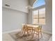 Elegant dining room with a large window, modern chandelier, and a stylish area rug at 4422 E Dry Creek Rd, Phoenix, AZ 85044