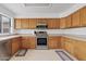 Well-lit kitchen featuring oak cabinets, stainless steel appliances, and tile flooring at 4422 E Dry Creek Rd, Phoenix, AZ 85044