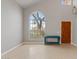 Bright living room featuring a large arched window, tile flooring, and neutral walls at 4422 E Dry Creek Rd, Phoenix, AZ 85044