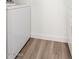 Clean laundry room featuring wood-look flooring and a modern white washer and dryer set at 623 W Guadalupe Rd # 288, Mesa, AZ 85210