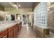 Luxurious bathroom featuring granite countertops, wood cabinetry, and tiled floors at 702 E Capricorn Way, Chandler, AZ 85249