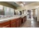 Luxurious bathroom featuring granite countertops, wood cabinetry, and tiled floors at 702 E Capricorn Way, Chandler, AZ 85249