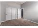 Neutral carpeted bedroom with closet and white doors and trim; natural light at 702 E Capricorn Way, Chandler, AZ 85249