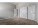 Bedroom features neutral carpet and closet with white sliding doors at 702 E Capricorn Way, Chandler, AZ 85249