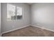 A cozy carpeted bedroom is filled with natural light from the large window at 702 E Capricorn Way, Chandler, AZ 85249