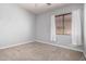 Bright bedroom features neutral carpet, window with blinds and white curtains at 702 E Capricorn Way, Chandler, AZ 85249