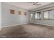 The spacious bedroom features a ceiling fan, neutral walls, carpet, and wood blinds at 702 E Capricorn Way, Chandler, AZ 85249