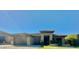 A charming single-story home featuring a three-car garage, desert landscaping, and a covered entryway at 702 E Capricorn Way, Chandler, AZ 85249
