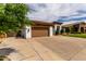 Lovely home exterior with a three-car garage, stucco walls, and a spacious concrete driveway at 702 E Capricorn Way, Chandler, AZ 85249