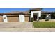 Attractive single-story home with a two-car garage, a well-kept lawn, and a stylish, covered entrance at 702 E Capricorn Way, Chandler, AZ 85249