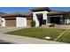Inviting single-story home with a well-manicured lawn, a two-car garage, and a stylish, covered entryway at 702 E Capricorn Way, Chandler, AZ 85249
