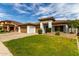 Inviting single-story home boasts a lush lawn, desert landscaping, and a three-car garage at 702 E Capricorn Way, Chandler, AZ 85249
