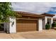 Three-car garage exterior featuring stucco walls and beautiful tiled roof at 702 E Capricorn Way, Chandler, AZ 85249